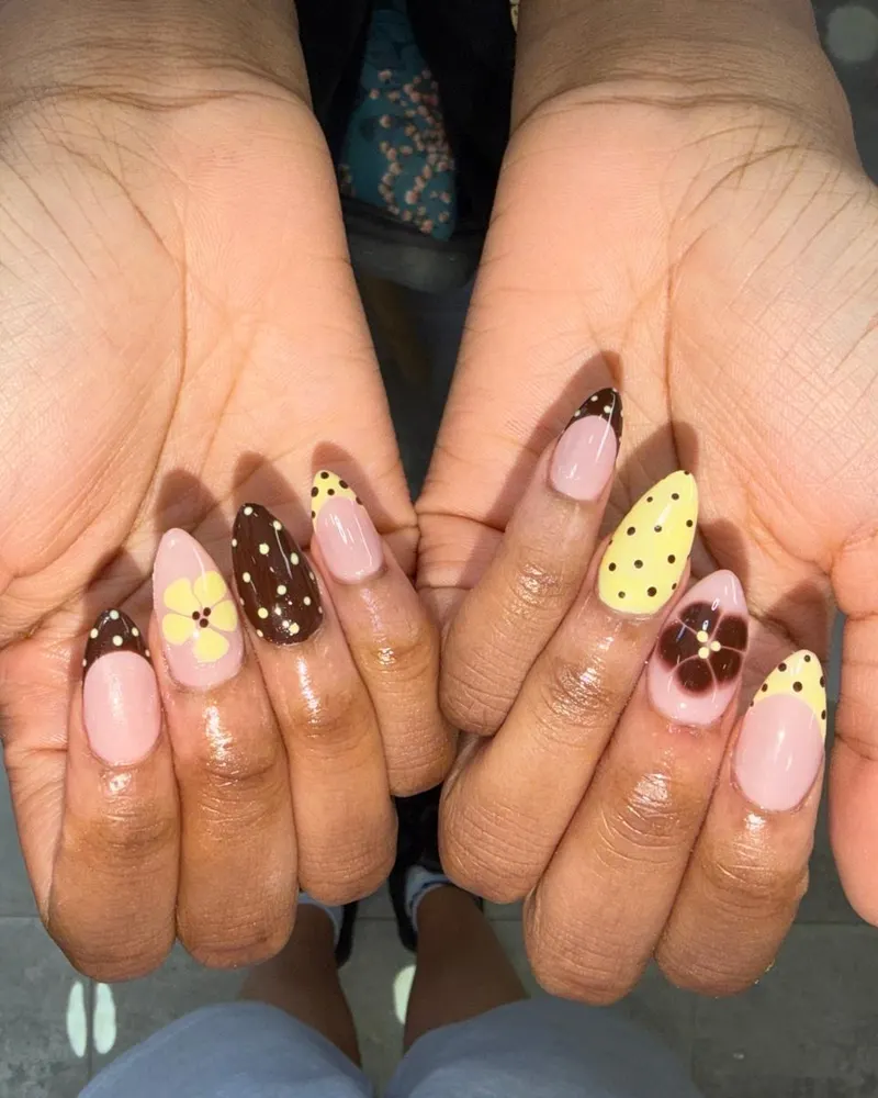 Short nails with brown and yellow polka dots and flowers
